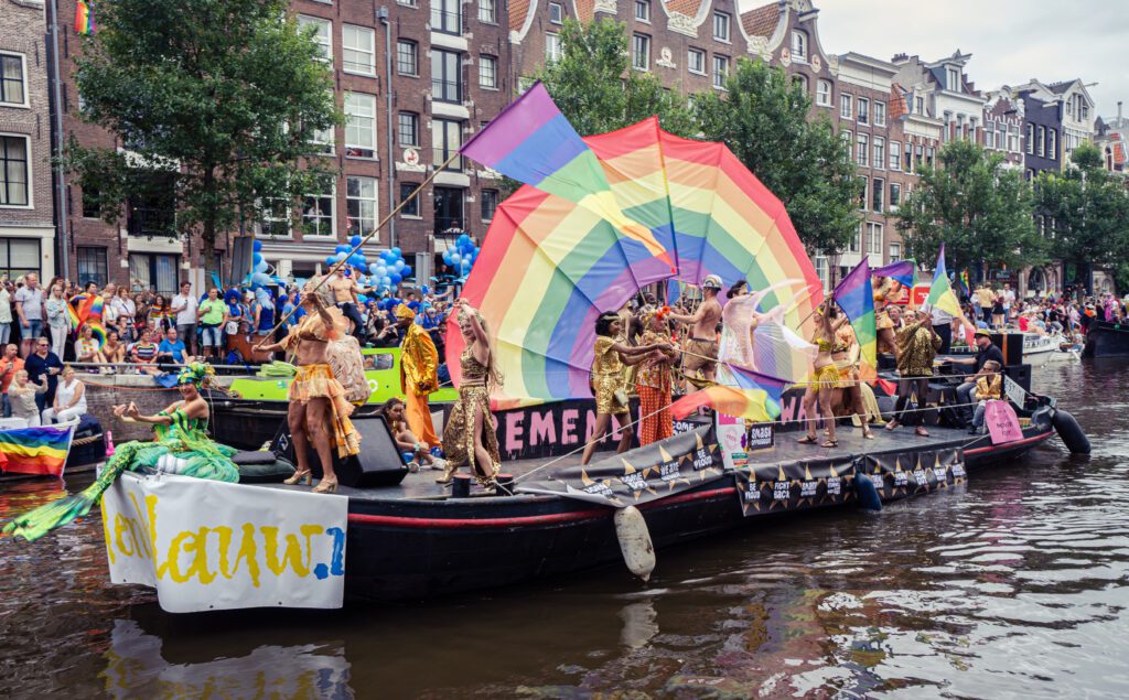 People dancing on a boat during canal parade Amsterdam