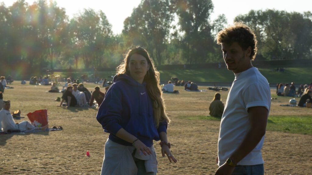Two people hanging out in a park in Amsterdam.