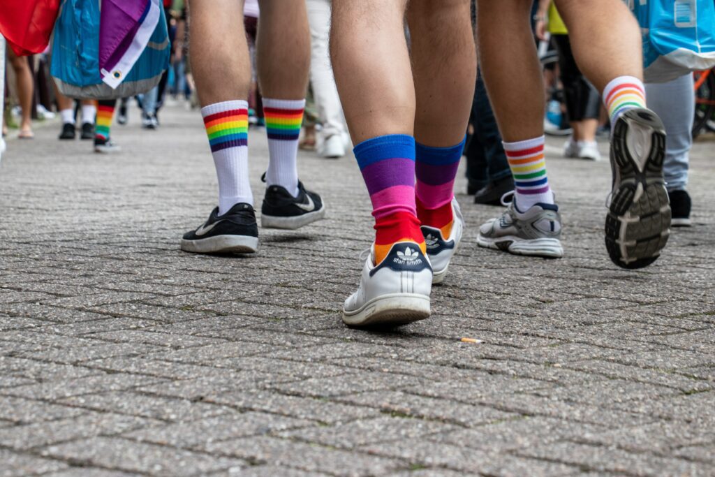 Close up from walking people with rainbow coloured socks.